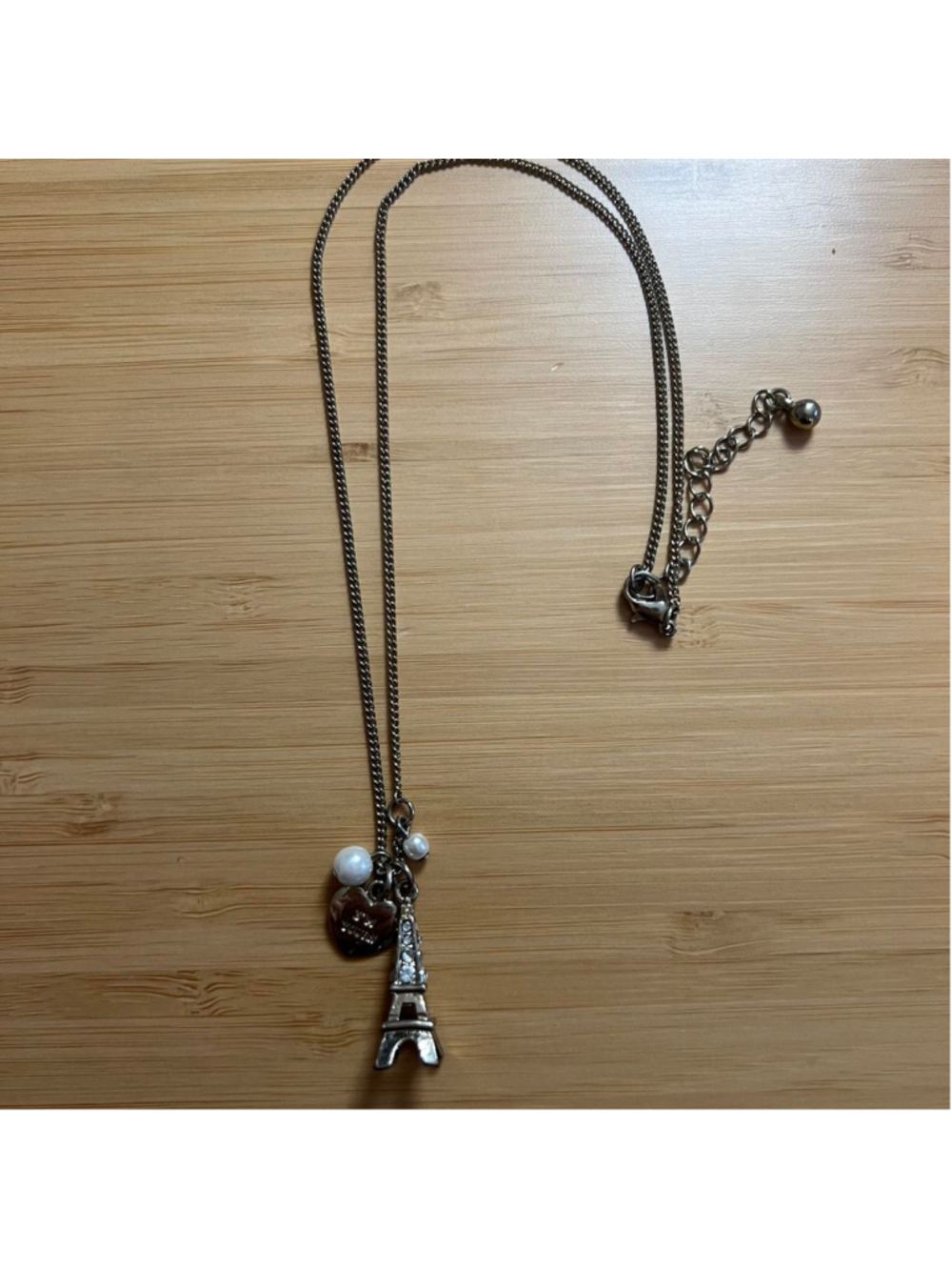 Gold necklace with Eiffel Tower, heart and pearl charms